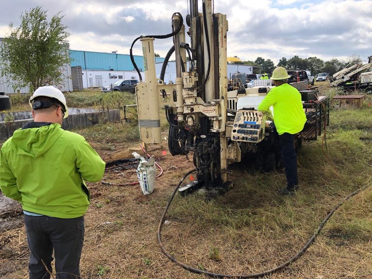 Two people around heavy machinery
